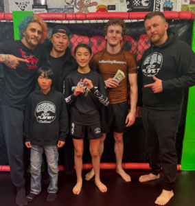 10th Planet Oakland coach Corbin Bilund and teammates after his submission victory at Pride of the Streets