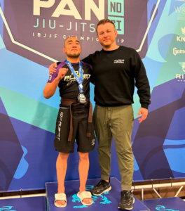 Jimmy Zhen with Michael Hillebrand after earning silver at the 2024 IBJJF No-Gi Pans and receiving his brown belt