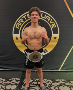Jonny Mezheritskiy with the Arte Suave Elite 145-pound Purple Belt Championship belt