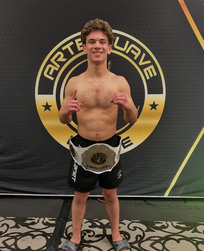 Jonny Mezheritskiy with the Arte Suave Elite 145-pound Purple Belt Championship belt
