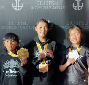 10th Planet Oakland youth competitors Mason Choi, Caitlyn Choi and Violet Choi with medals at the Jiu Jitsu World League Finals