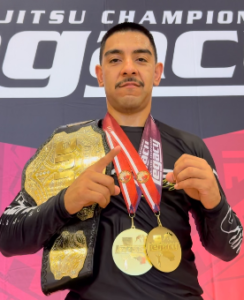Tony Plasencia with two gold medals and the absolute championship belt after winning double gold at Legacy Jiu Jitsu