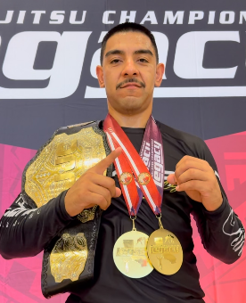 Tony Plasencia with two gold medals and the absolute championship belt after winning double gold at Legacy Jiu Jitsu