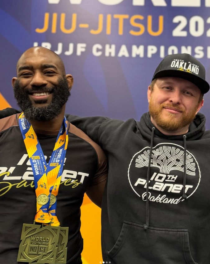 Chris Clark wearing two medals beside a teammate at the 2025 IBJJF No-Gi Worlds