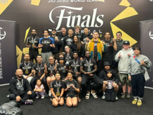 10th Planet Oakland team members posing with medals in front of the 2025 JJWL Finals NorCal backdrop