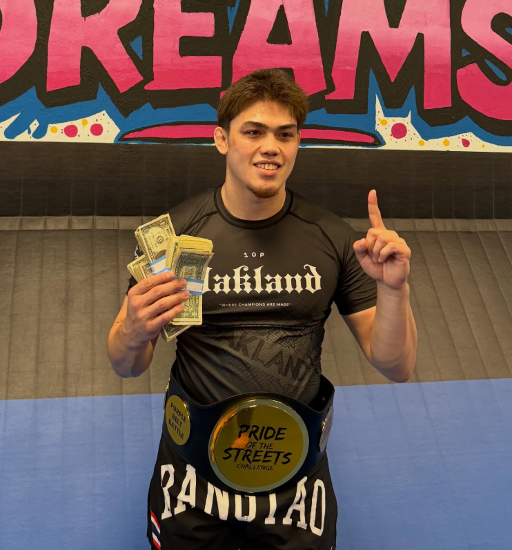 Mason Boutain wearing an Oakland rashguard and Pride of the Streets championship belt